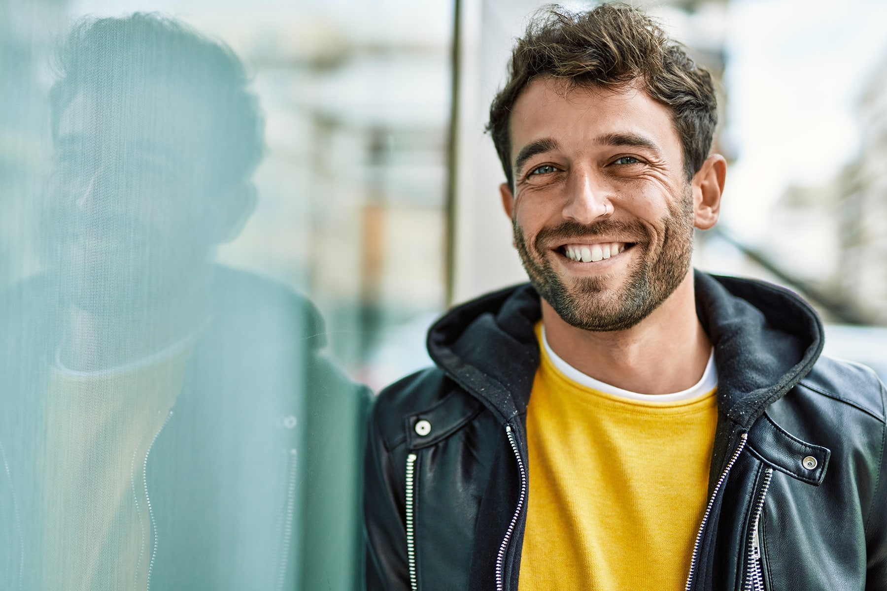 Man smiling after visiting the restorative dentist in Apex, NC