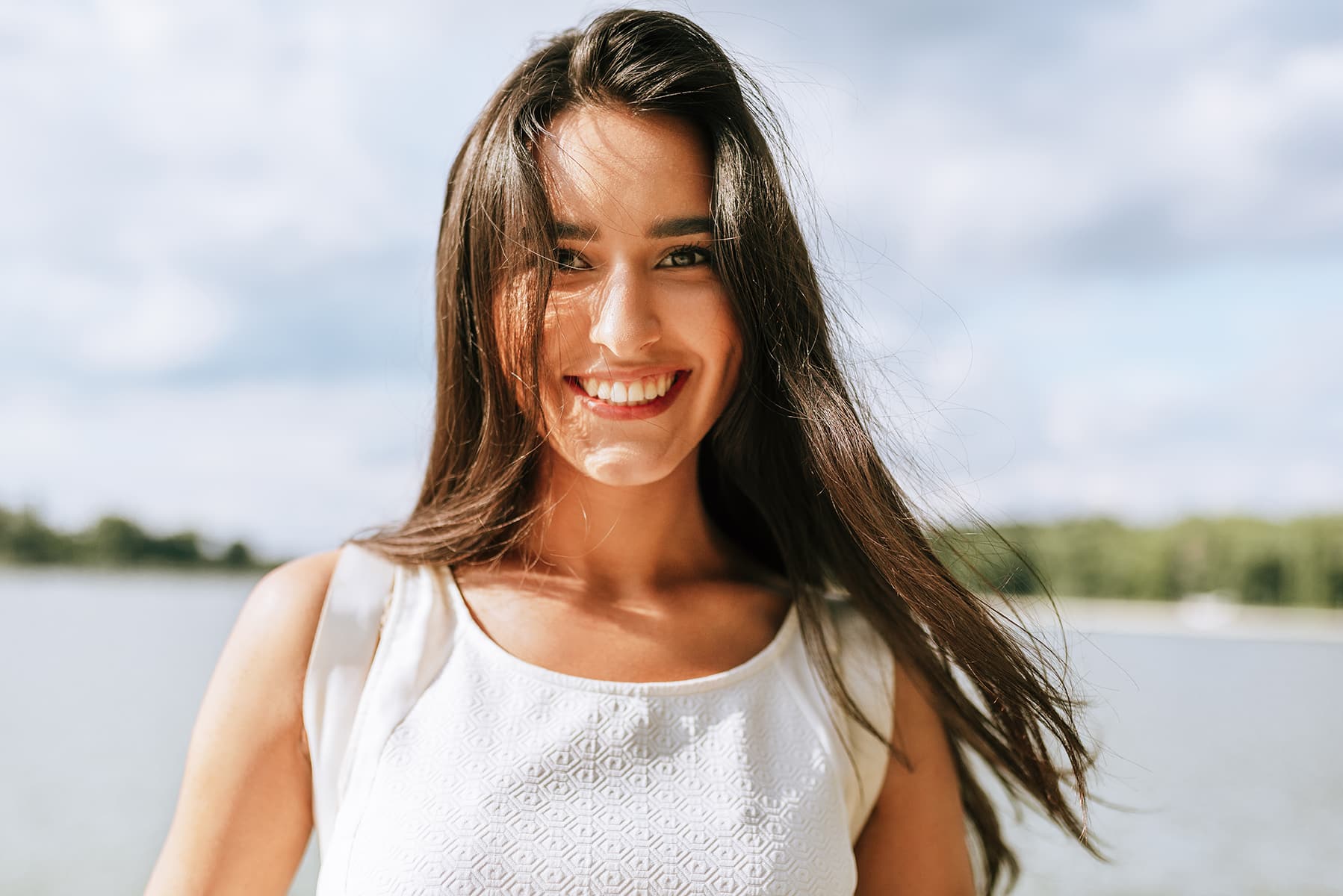 Woman smiling after getting dental repairs in Apex, NC