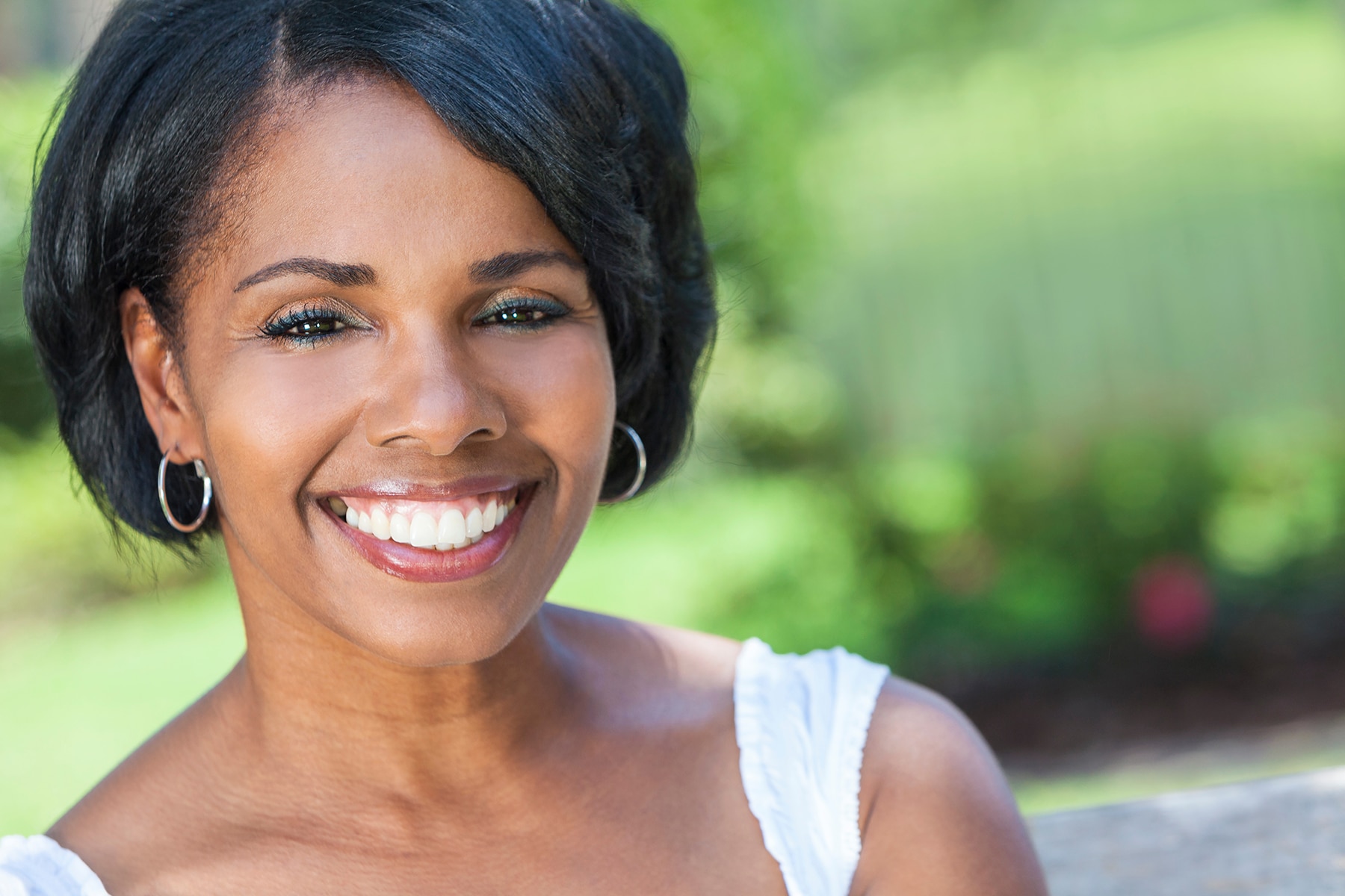 Woman smiling after getting dental implants in Apex, NC