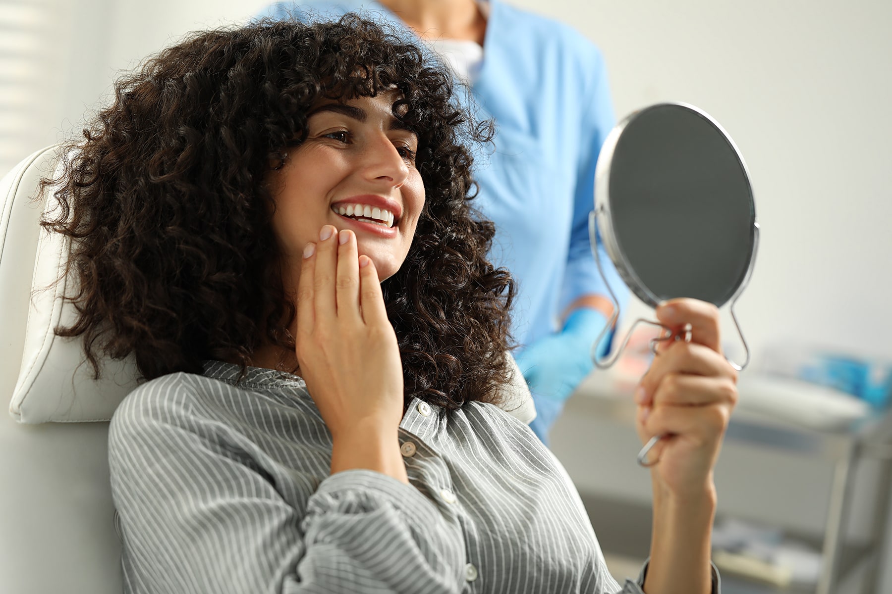 Woman smiling after dental whitening in Apex, NC